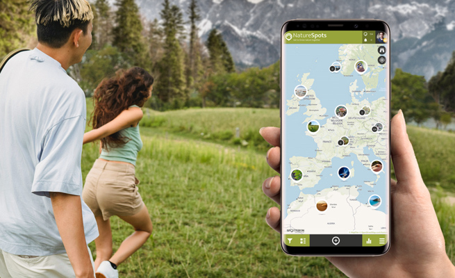 NatureSpots App on a Smartphone with people running into nature